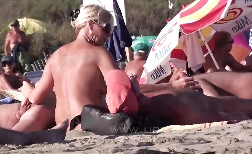 Blonde milf jerking dick on public nude beach